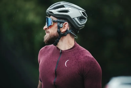guy wearing a bicycle helmet and maroon riding jersey